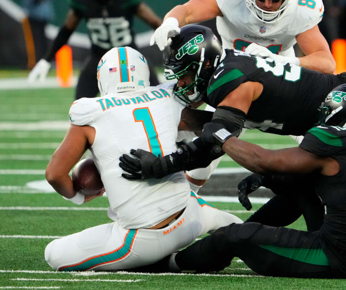 Nov 24, 2023; East Rutherford, New Jersey, USA; New York Jets defensive end Solomon Thomas (94) sacks Miami Dolphins quarterback Tua Tagovailoa (1) in then second quarter at MetLife Stadium. Mandatory Credit: Robert Deutsch-USA TODAY Sports
